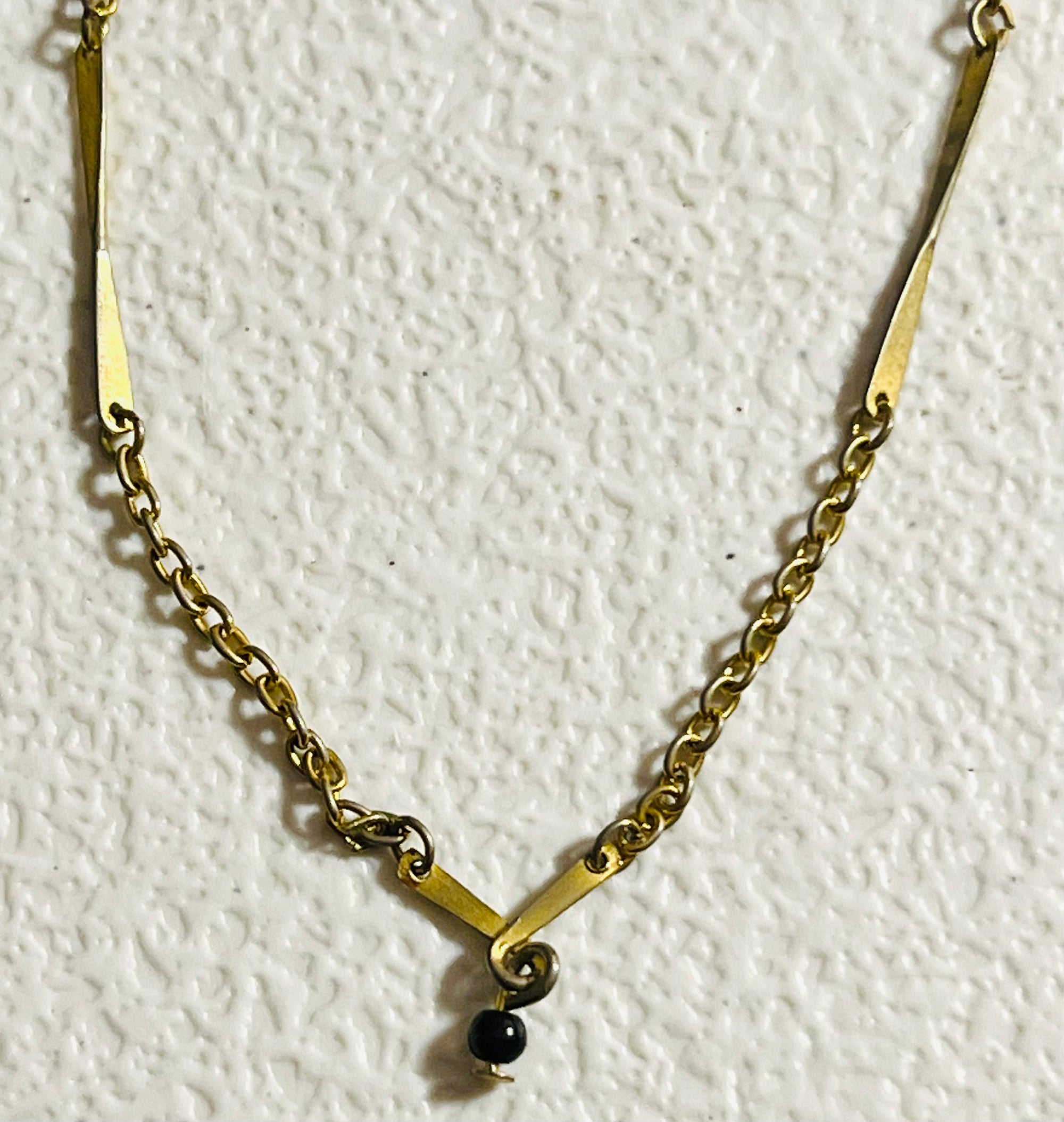 Vintage Avon, gold tone chain with twisted bar, vintage necklace and twisted bar pendant with hanging black bead 15 inch necklace